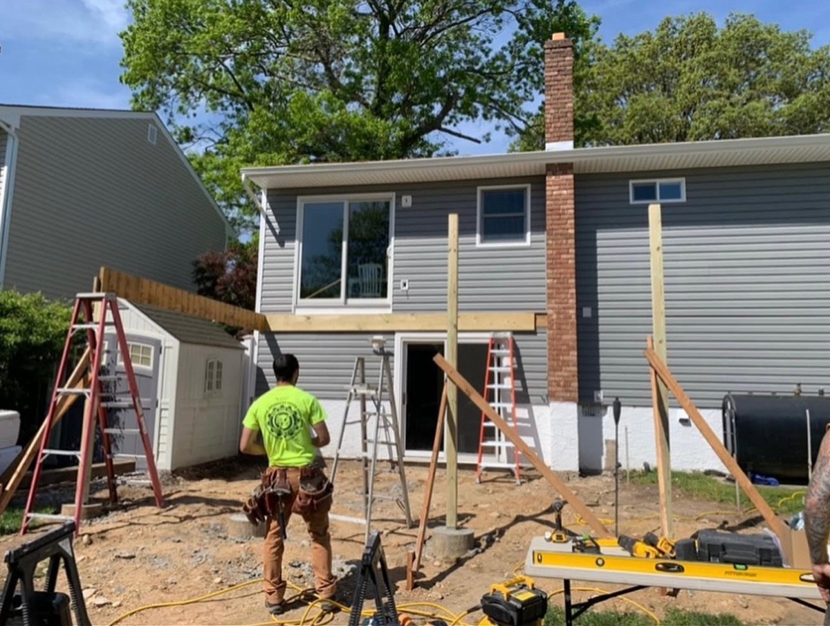 Before — rear of the home under construction with the deck being framed
