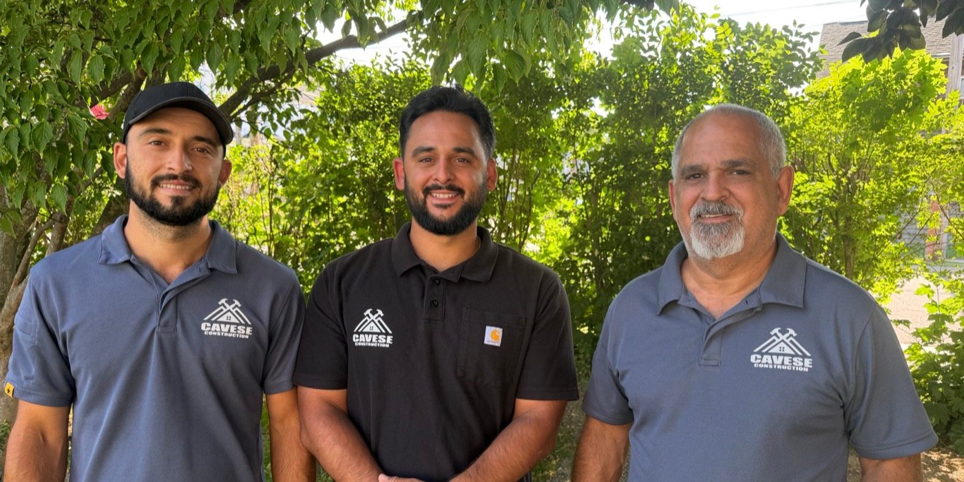 The Cavese Construction family team in branded polos outside on a sunny day
